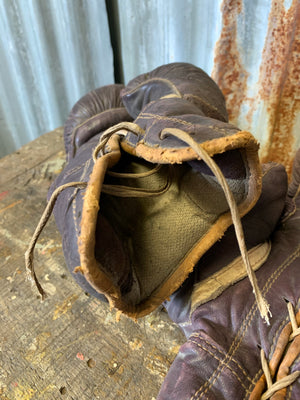 A vintage pair of brown leather Spalding boxing gloves