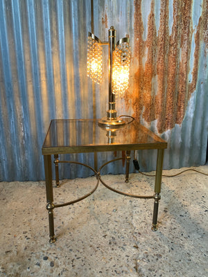 A Hollywood Regency square side table with smoked glass