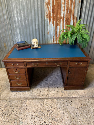 A blue leather pedestal desk