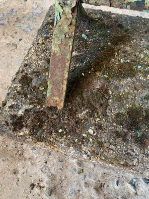 A large stone and cast iron boot scraper