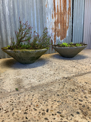 A pair of modernist cast stone conical garden planters
