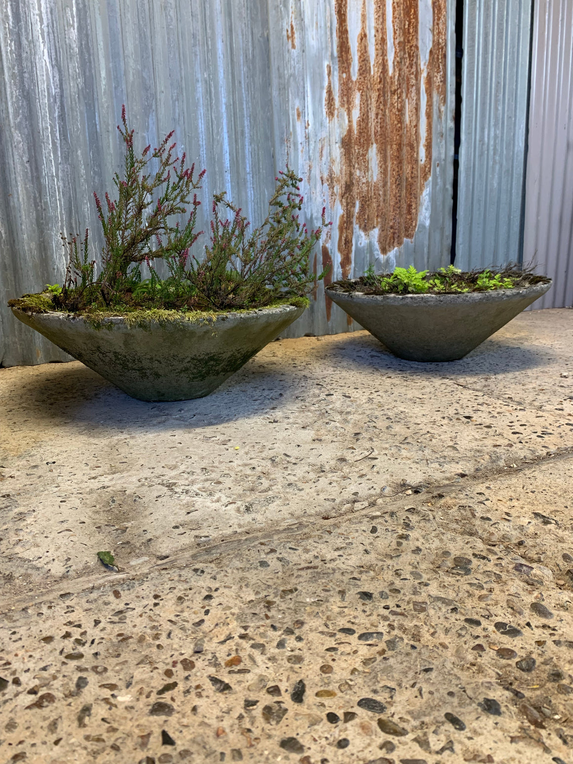 A pair of modernist cast stone conical garden planters