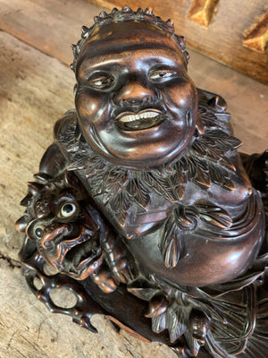 An opposing pair of hand carved reclining buddhas in rosewood