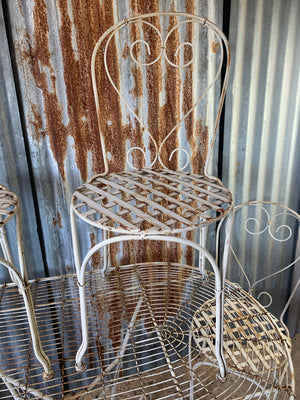 A white French wirework garden table and four chairs