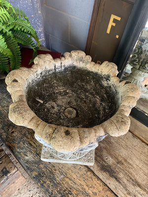 A pair of large tulip or acanthus pattern cast stone urns