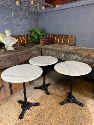 A black cast iron bistro table with marble top 2/3