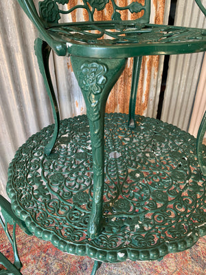 A green Victorian style table and two chairs set