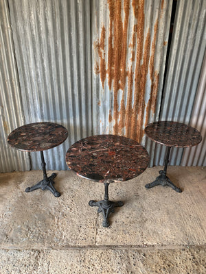 A black cast iron bistro table with red Palladio granite top - large (one available)