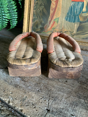A pair of wood and straw geta