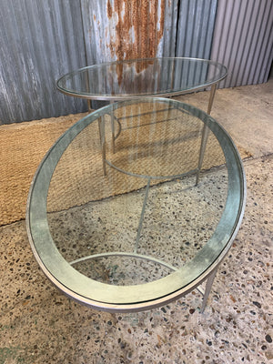 A large oval steel and glass coffee table by Pierre-Yves Rochon