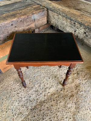 A Victorian single drawer table with ebonised top and glass handles