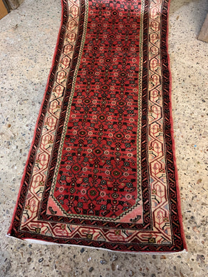 A long pink and red ground Persian Hosseinabad runner rug