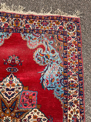 A red ground Persian rectangular rug- 188cm x 124cm