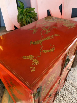 A red and gold lacquer Chinoiserie cabinet