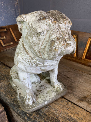 A cast stone bulldog statue