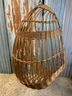 A rattan hanging egg chair