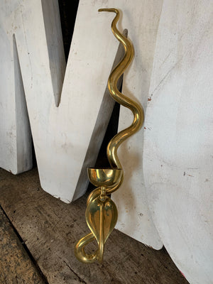 A brass Egyptian Revival style cobra wall sconce