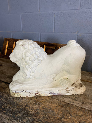 A pair of white cast stone lion and ram statues