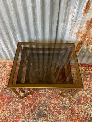 A brass and smoked glass Hollywood Regency nest of tables