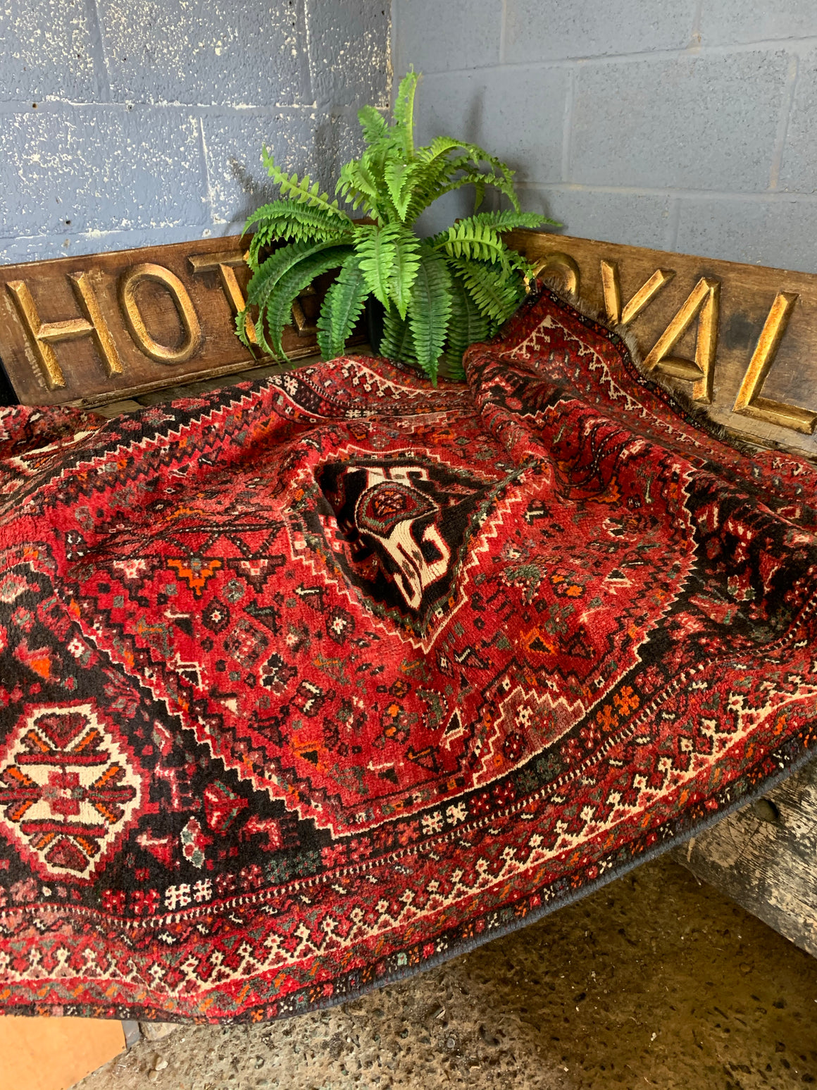 A hand woven Persian red ground rectangular rug