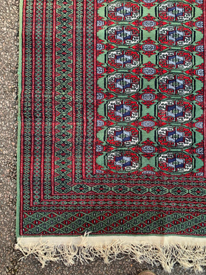 A Persian Bokhara rectangular rug - red/green tones