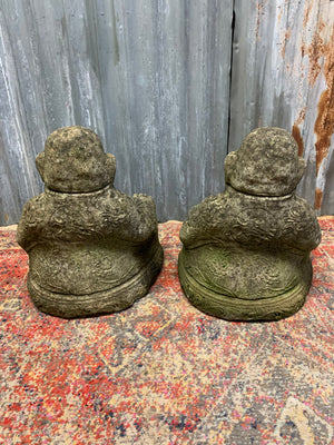 A pair of cast stone laughing Buddhas