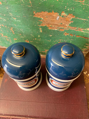 A pair of blue porcelain apothecary jars with gold glass labels