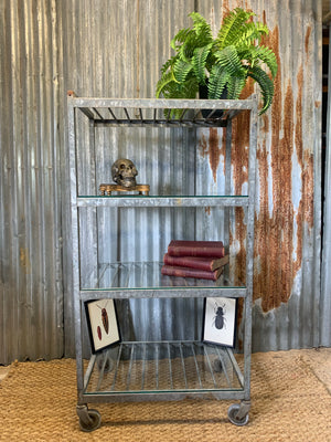 A vintage industrial steel and glass shelving unit
