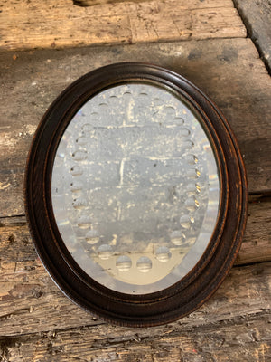 A 19th Century sorcerer’s mirror in an oval mahogany frame
