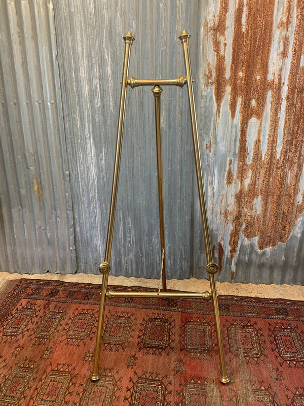 A brass full size floor standing display easel Belle and Beast Emporium