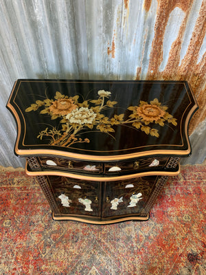 A black lacquered Chinoiserie cabinet