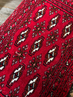 A red ground Persian carpet cushion