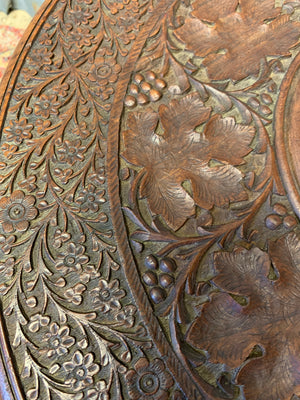 An Anglo-Indian circular carved table with brass inlay