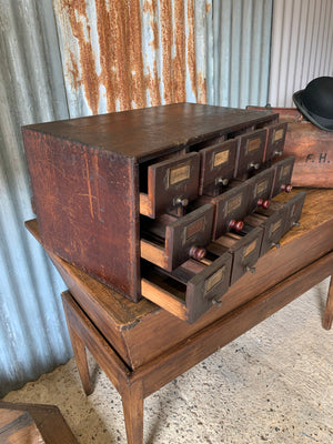 A wooden bank of 12 drawers
