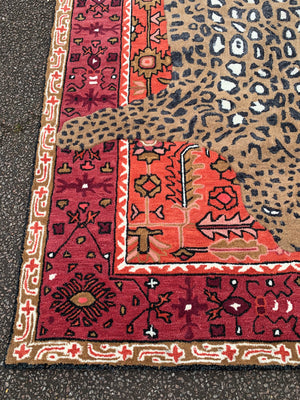 A large Persian style rug with faux taxidermy leopard - 214cm x 153cm