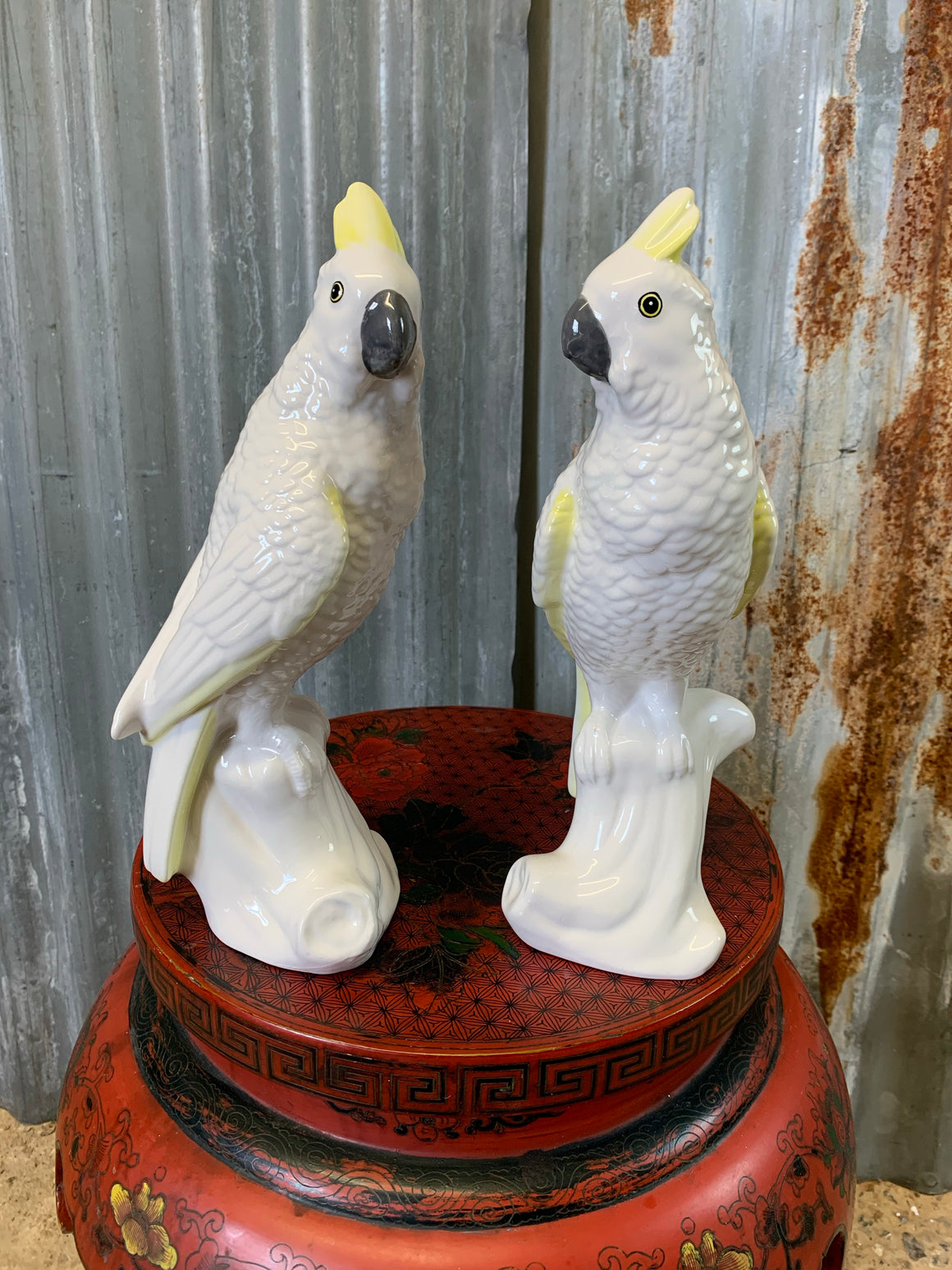 A pair of white porcelain cockatoo statues