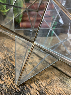 A glass and brass star ceiling light