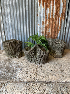 A cast stone faux bois planter