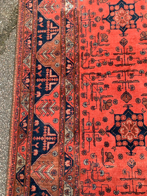A hand woven Persian orange ground rectangular rug