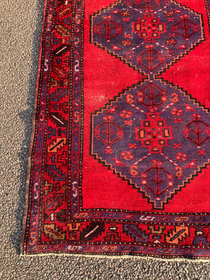 A red ground runner rug - 207cm x 108cm