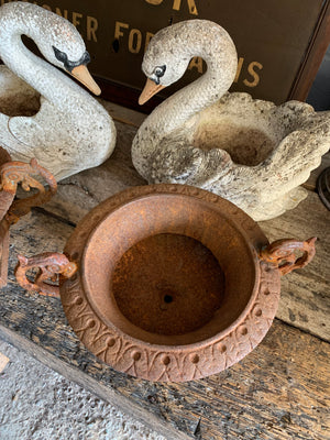 A pair of cast iron urns with handles