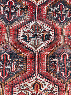 A large red ground Persian rectangular rug- 237cm x 158cm