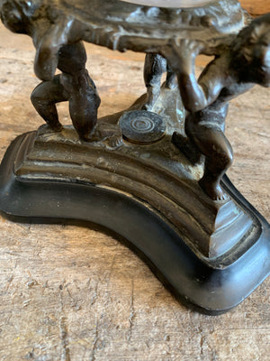 A fortune teller's crystal ball on a bronze and marble stand