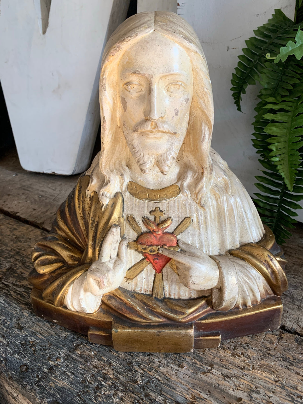 A plaster bust of Jesus with flaming Sacred Heart