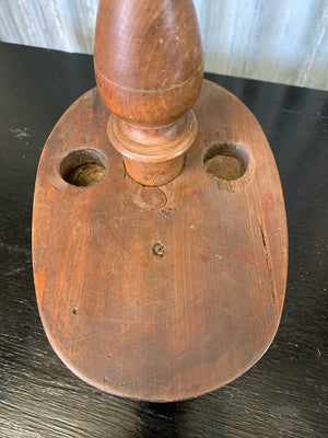A wooden millinery kepi hat form
