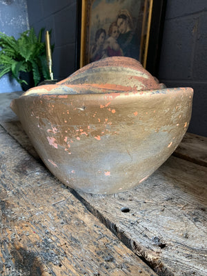 A large terracotta seashell planter