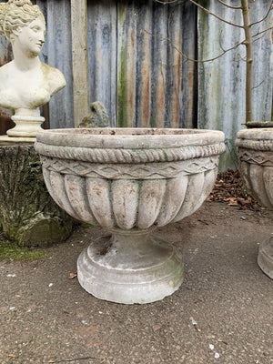 A pair of large cast stone urns