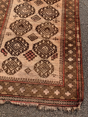 A large rectangular brown ground Persian rug