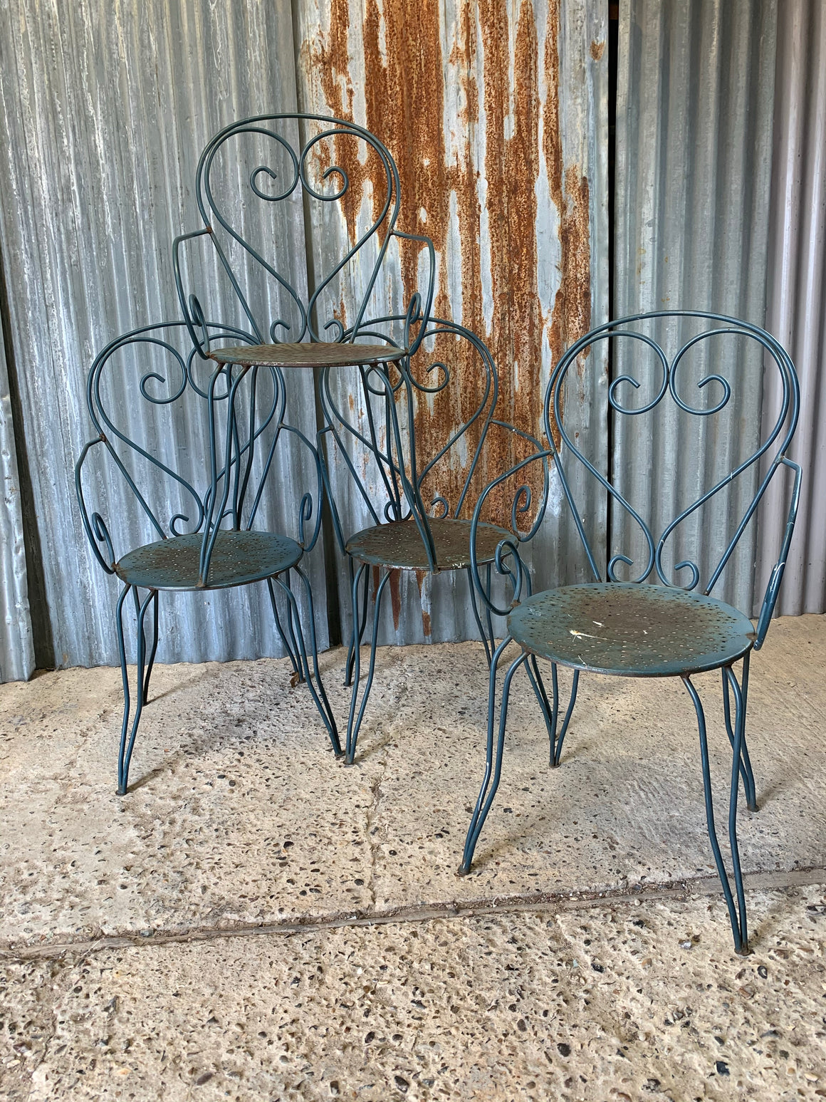 A set of four French blue wire work garden chairs