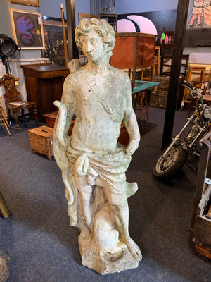A very large stone garden statue of Apollo the Hunter